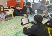 Students working on tablets at recycled plastic desk
